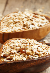 Homemade muesli in a bowl in the shape of a heart on a wooden ta