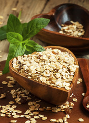 Homemade muesli in a bowl in the shape of a heart on a wooden ta