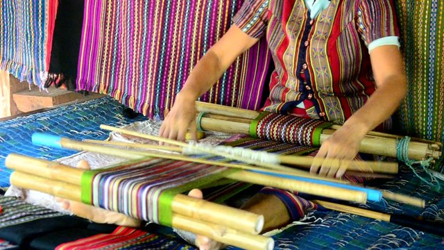 Laos Women weave cloths and sell cloth for show  traveler