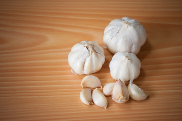 Group of white garlic on wooden background