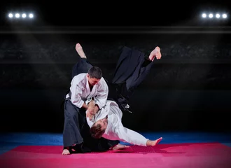 Acrylic prints Martial arts Fight between martial arts fighters at sports hall