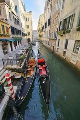 2 gondolas on a canal in Venice, Italy