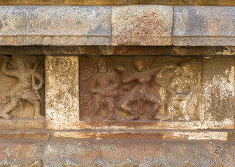 Dancing figure on plinth.