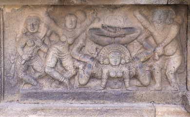 Mural sculpture of acrobatic dancing.