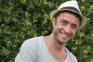 Man with hat smiling to the camera