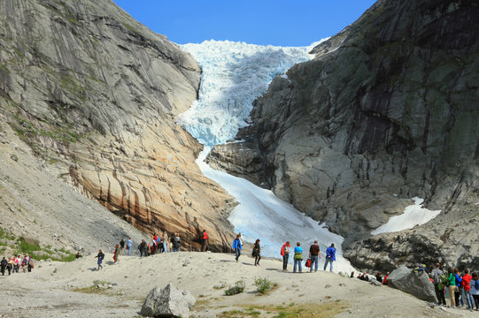 Tourists and glacier in mountains, Norway