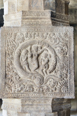 Sculpture on pillar of naked dancing woman.