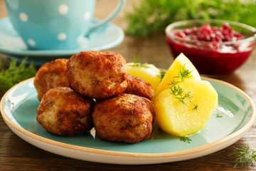 Hot meatballs with boiled potatoes and cranberry sauce ..