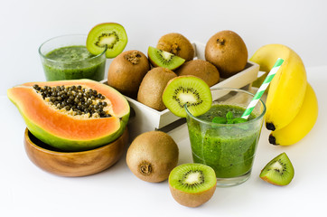 Green tropical smoothie with kiwi, papaya and bananas white back