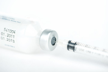 Closed up Injection preparation with ampoule and syringe on whit