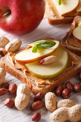 Sweet sandwich with peanut butter and apple close up