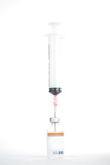 Injection preparation with vial and syringe on white