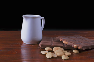 Chocolate, milk and cookies on wood