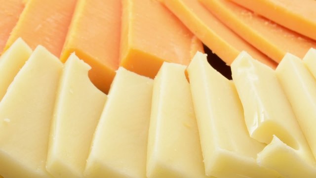 Pan across slices of cheese low angle view
