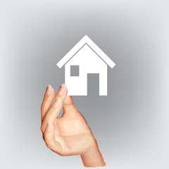 hand holding a house made of paper vector