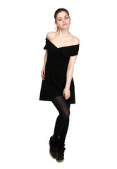 Fototapeta premium Young girl dressed in casual black dress and black sneakers