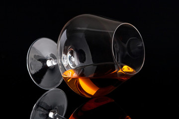 Laying brandy glass isolated on black