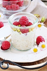 Overnight oats with fresh raspberry and pistachio.