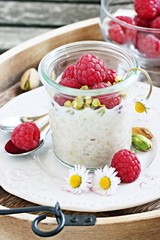 Overnight oats with fresh raspberry and pistachio.