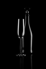 champagne glass and bottle on black