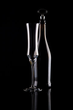 champagne glass and bottle on black