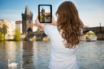 Fototapeta na wymiar Beautiful young tourist woman photographing sites in Prague Czec