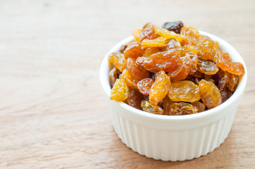 Heap of Raisins on vintage wooden background