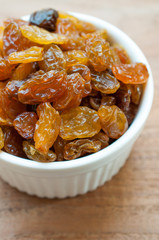 Heap of Raisins on vintage wooden background