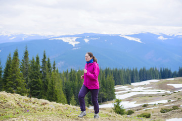 young caucasian female running in montains