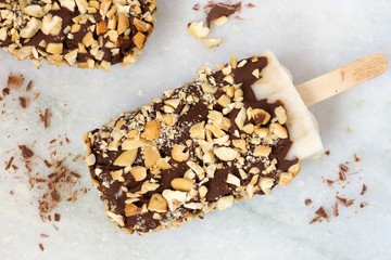 Homemade chocolate dipped popsicles with nuts