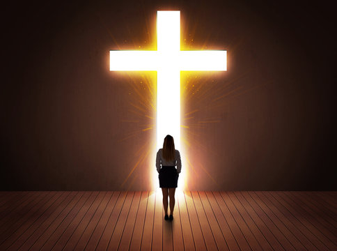 Woman Looking At Bright Cross Sign