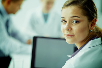 Medical team sitting at the table in modern hospital