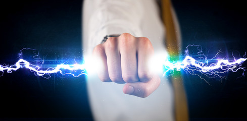 Business man holding electricity light bolt in his hands