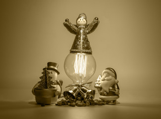 Angel on light bulb with Santa and Snow man