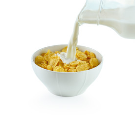 tasty cornflakes in white  bowl and glass of milk on white backg