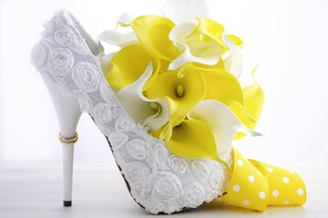 Wedding ring on beautiful white stiletto shoe heel.