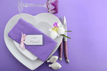 Purple theme wedding table place setting.