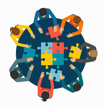 Businesspeople joining puzzle pieces 