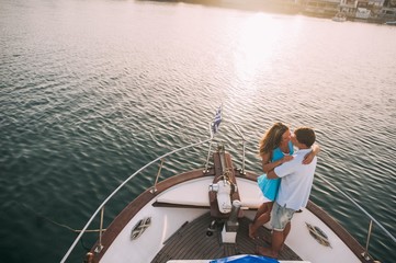 Couple in hug relaxing on the luxury yacht cruise