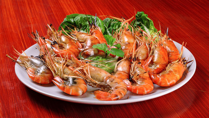 Plate of grilled shrimps with spicy sauce