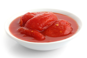 Whole canned tomatoes in white dish. Isolated.