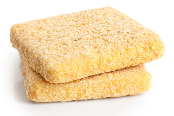 Uncooked an frozen fried chees on white.