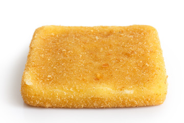 Single square golden fried cheese on white.