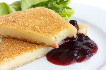 Fried cheese, cut, melting, cranberry sauce, salad. Bite.