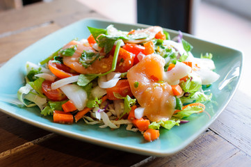 Spicy salmon salad with mixed vegetable and herb