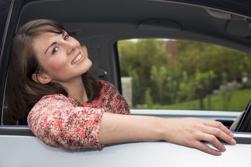 Fototapeta na wymiar portrait of young woman sitting in a car