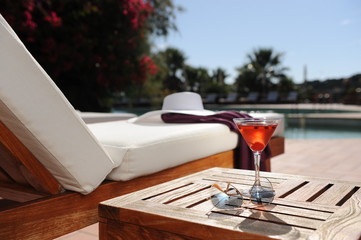 soft drink in a beach chair by the pool of a luxury hotel
