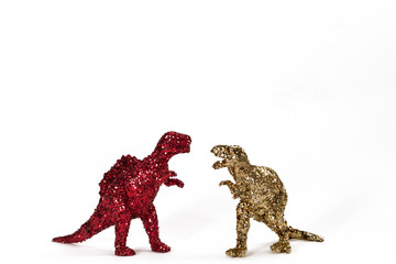 Dinosaurs in red and gold glitter on white. Landscape.