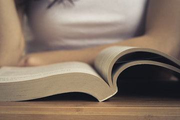 Open book on wooden table closeup