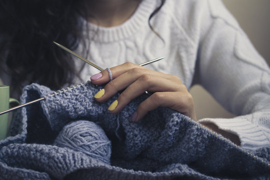 Knitted From A Gray Yarn Sweater And Thread For Knitting Closeup